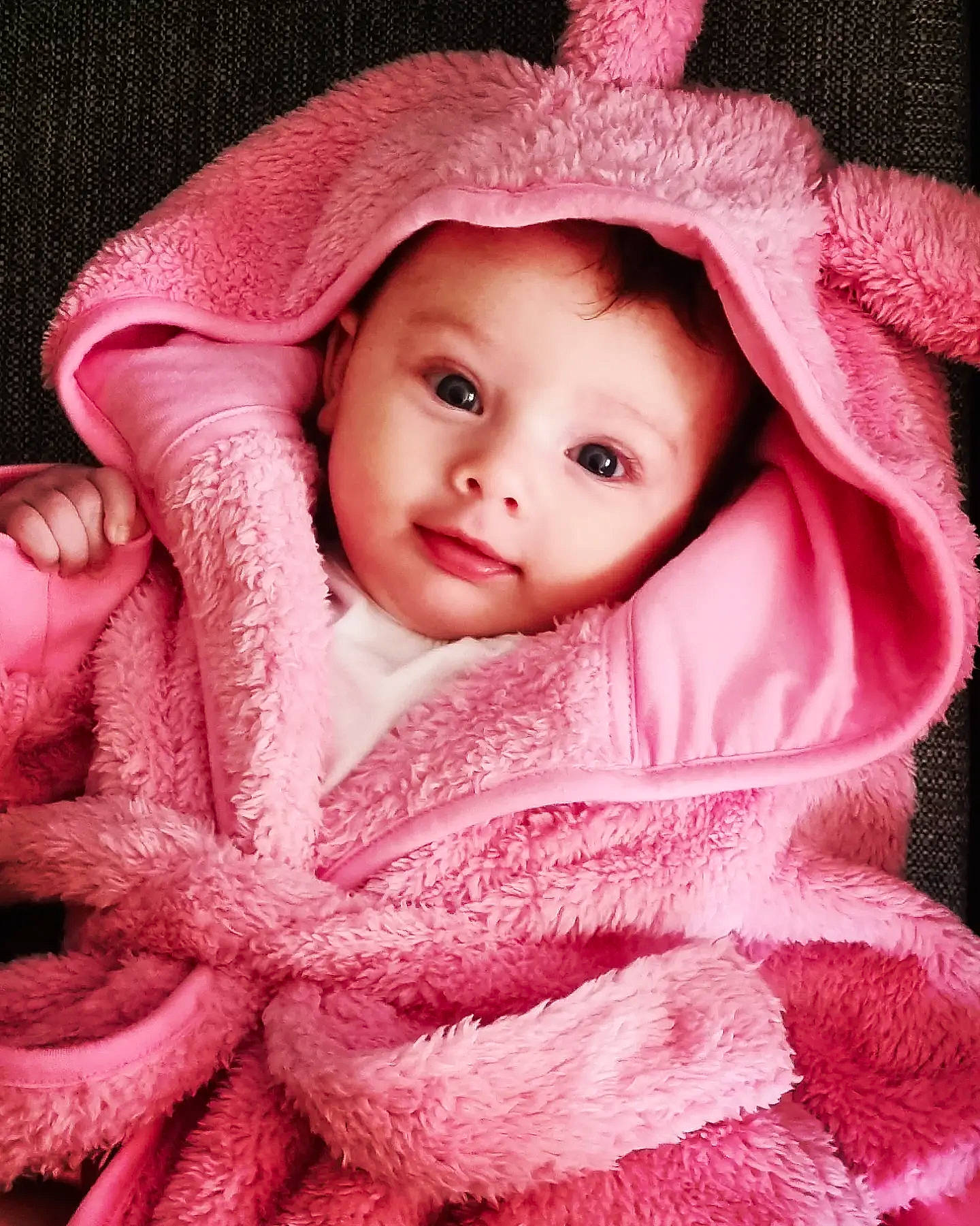 Amara is registered to the contest to win money with this photo: baby, baby_toddler_clothing, cap, face, headgear, headwear, linens, lip, magenta, outerwear, pattern, person, pink, product, red, skin, sleeve, smile, textile, toddler