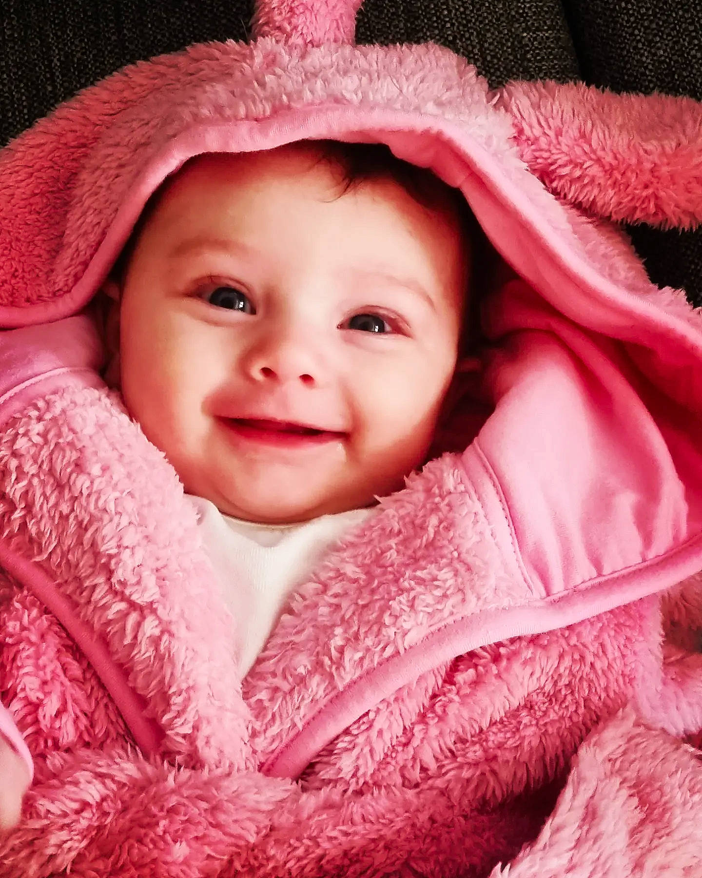 Amara is registered to the contest to win money with this photo: baby, cheek, child, chin, eye, eyebrow, face, flash_photography, happy, hat, headwear, iris, joy, lip, magenta, outerwear, person, pink, skin, sleeve