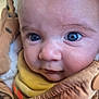 Owen participe au concours pour gagner de l'argent avec cette photo : baby, close_up, blue_eyes, face, infant, jacket, yellow_clothing, skin, cute, child, portrait, expression, warm, soft_light, young, person, wrapped, cozy, indoor, texture