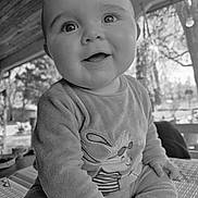 Owen a rejoint le concours — aidez-le/la à gagner de superbes lots ! baby, black_and_white, bunny_design, cheeks, close_up, clothing, cozy, cute, eyes, hands, happy, infant, onesie, outdoor_background, porch, portrait, sitting, smile, soft_texture, table