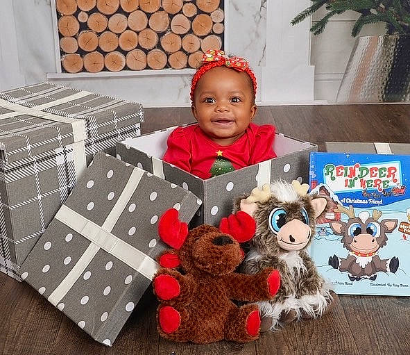 Khalani joined the competition — help win amazing prizes! baby, baby_toddler_clothing, carmine, child, christmas, fur, happy, houseplant, joy, linens, mammal, paper_product, pattern, person, plaid, rectangle, room, smile, stuffed_toy, textile