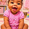 baby, child, infant, smiling, happy, portrait, sitting, pink_outfit, polka_dots, hair_buns, curly_hair, earrings, nursery, teddy_bear, toys, bookshelf, crib, rug, indoors, close_up