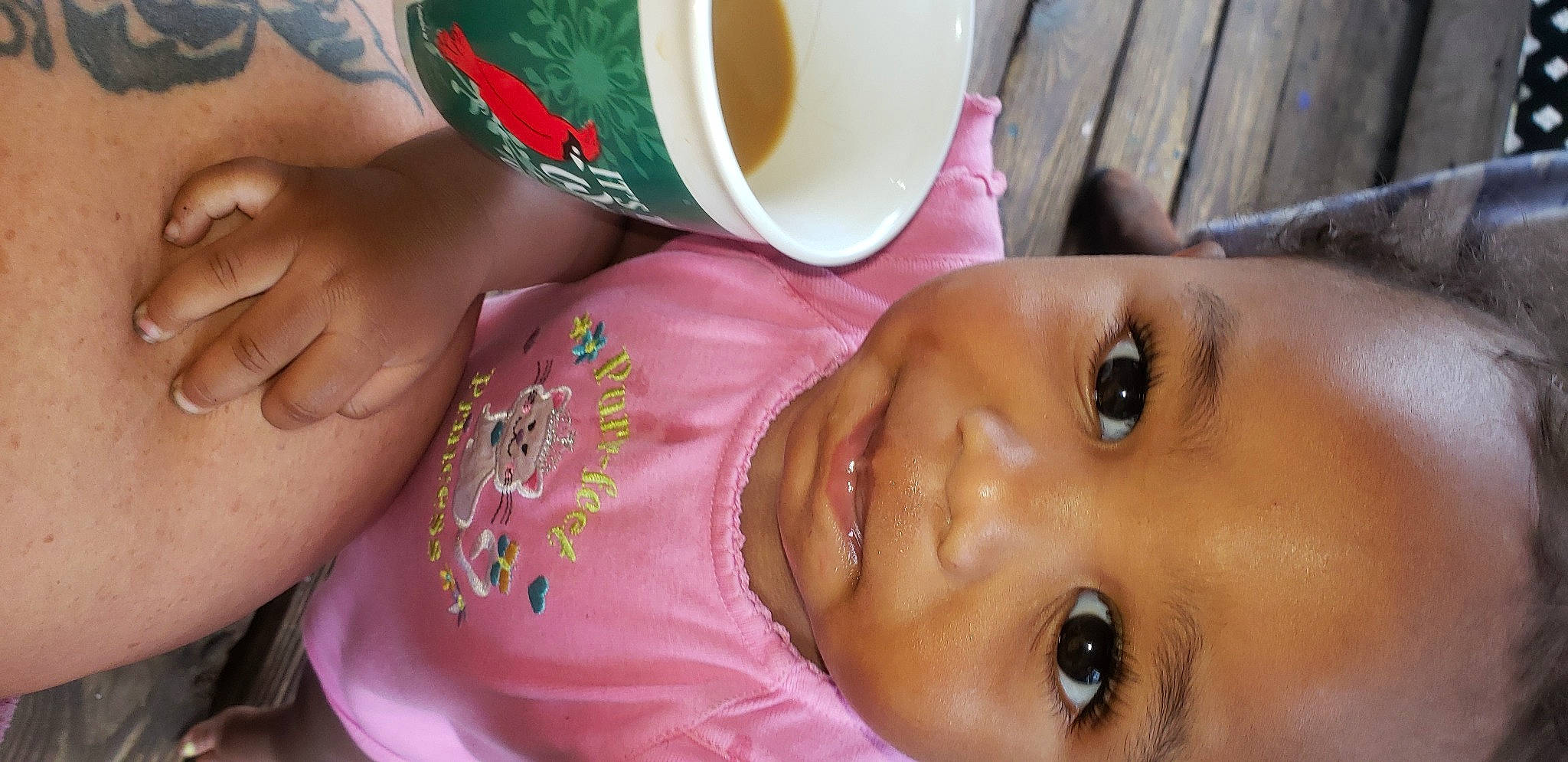 Rainey is registered to the contest to win money with this photo: baby, cheek, coffee_cup, cup, drinkware, ear, eyelash, food, happy, lip, mouth, neck, nose, person, serveware, skin, smile, tableware, teacup, toddler