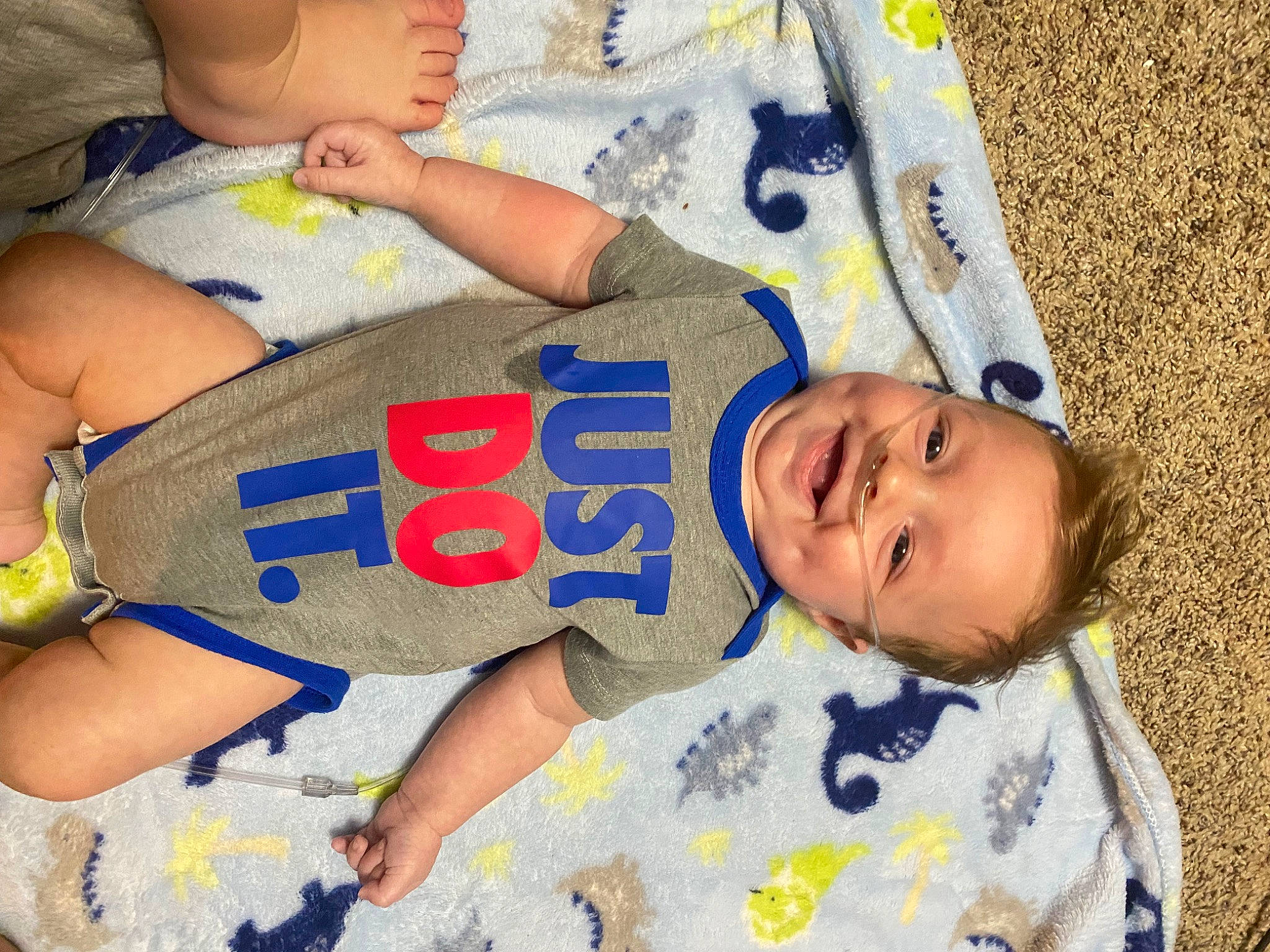 Colt is registered to the contest to win money with this photo: baby, baby_toddler_clothing, cheek, child, face, facial_expression, finger, hand, head, human_body, joy, mouth, organ, people, person, product, skin, sleeve, smile, textile