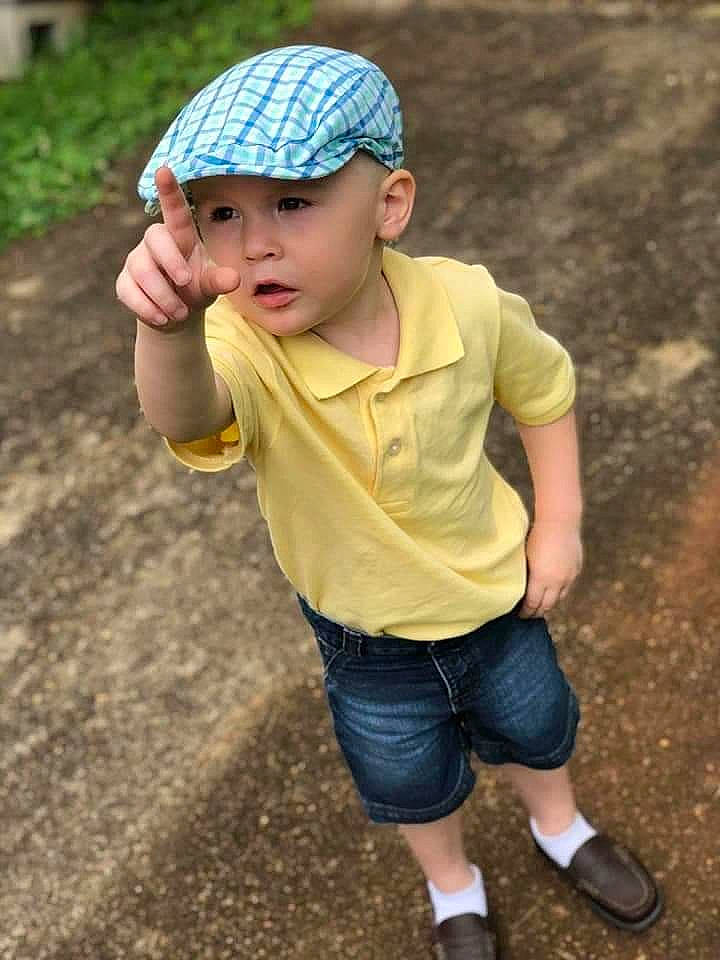 Negan is registered to the contest to win money with this photo: baby, beanie, cap, child, child_model, clothing, cool, fun, headgear, headwear, person, play, recreation, sleeve, smile, t_shirt, toddler, yellow