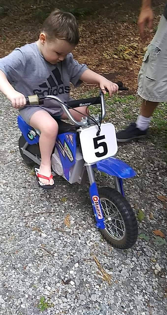 Negan is registered to the contest to win money with this photo: auto_part, automotive_tire, automotive_wheel_system, car, motorcycle, person, rim, vehicle