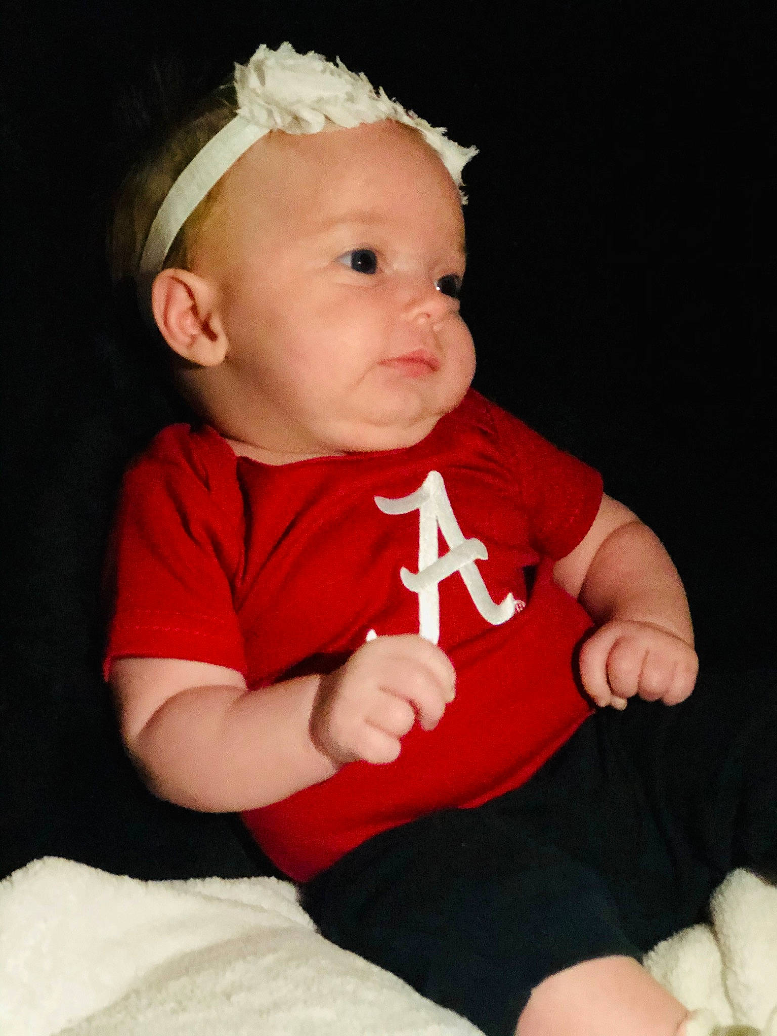 Madilynn is registered to the contest to win money with this photo: arm, baby, baby_toddler_clothing, cheek, child, finger, hair_accessory, hand, headband, headgear, lip, person, red, sitting, skin, smile, toddler