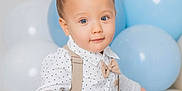 Justin joined the competition — help win amazing prizes! toddler, child, baby, blue_eyes, mohawk, polka_dot, shirt, suspenders, bow_tie, balloons, blue, white, couch, hand, curious, portrait, indoor, cute, fashion, smile