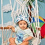 Justin joined the competition — help win amazing prizes! baby, child, hat, onesie, stitch, macrame, hanging_chair, indoor, umbrella, palm_tree, blue_background, smiling, cute, sitting, footwear_bare, infant, clothing, portrait, hand, playful