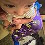 baby, blanket, blue_sock, candid, carpet, child, close_up, eyes, floor, footwear, hands, holding, home, indoor, infant, pacifier, pajamas, person, purple_clothing, striped_shirt