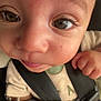 baby, close_up, face, eyes, infant, car_seat, seatbelt, fist, cute, child, skin, expression, young, human, portrait, clothing, hand, straps, detail, innocence