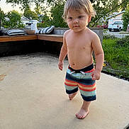 Aj is registered to the contest to win money with this photo: toddler, child, barefoot, shorts, outdoor, patio, concrete, trees, greenery, bench, cushions, house, car, daylight, summer, person, cute, young, walking, casual