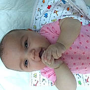 Nevaeh joined the competition — help win amazing prizes! baby, infant, pink_onesie, blanket, animal_print, hand, chewing, face, lying_down, cute, child, toddler, smile, skin, head, eyes, indoors, soft_lighting, closeup, portrait