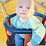 baby, child, clothing, cute, expression, eyes, face, footwear, hand, jeans, metal_chain, outdoor, person, playground, seat, shadow, sock, sunlight, sweater, swing