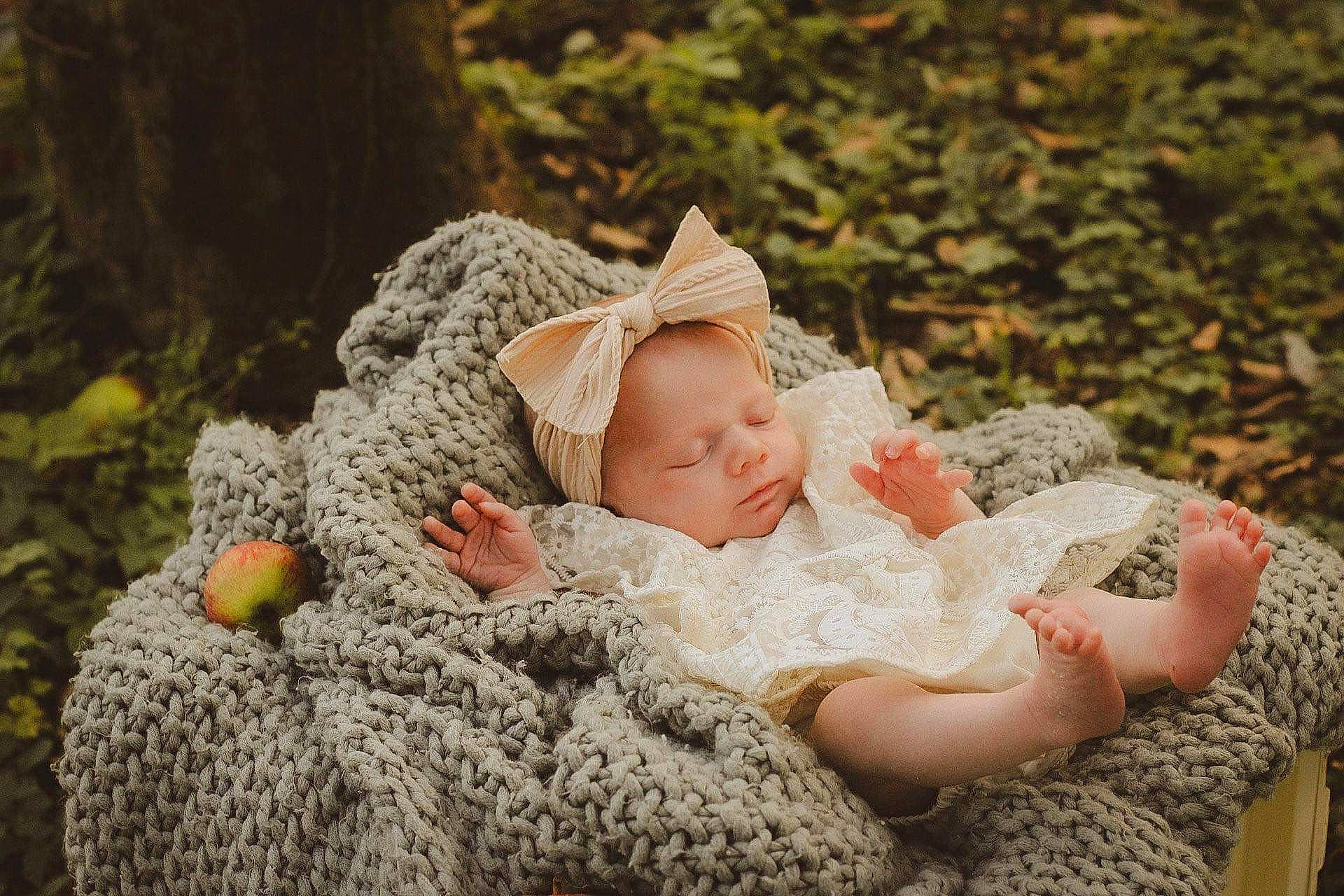 Blair is registered to the contest to win money with this photo: baby, baby_toddler_clothing, cap, child, comfort, dress, embellishment, fashion_accessory, flash_photography, fur, grass, happy, hat, people_in_nature, person, plant, sitting, sleeve, toddler, tree