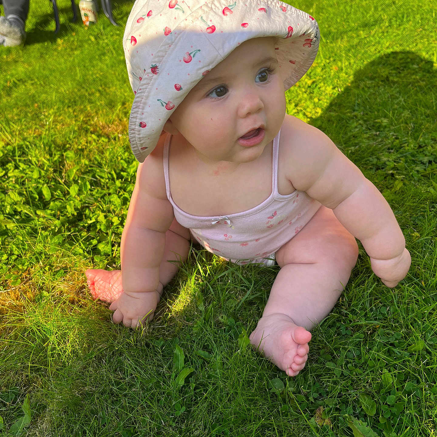 Violet is registered to the contest to win money with this photo: baby, bonnet, cap, car, clothing, face, footwear, grass, hat, head, lawn, person, photography, plant, portrait, shoe, summer, sunhat, transportation, vehicle