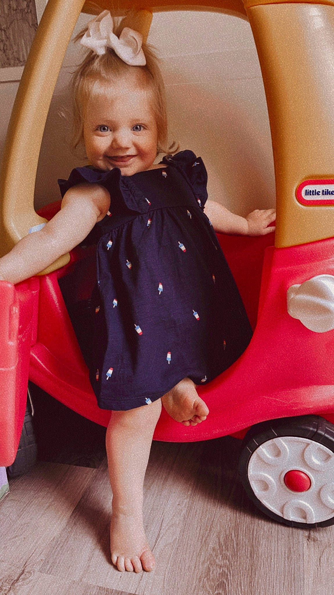 Jaycee joined the competition — help win amazing prizes! automotive_design, automotive_tire, baby_toddler_clothing, child, dress, fender, fun, happy, human_leg, joy, leg, magenta, motor_vehicle, person, pink, riding_toy, sitting, smile, thigh, tire