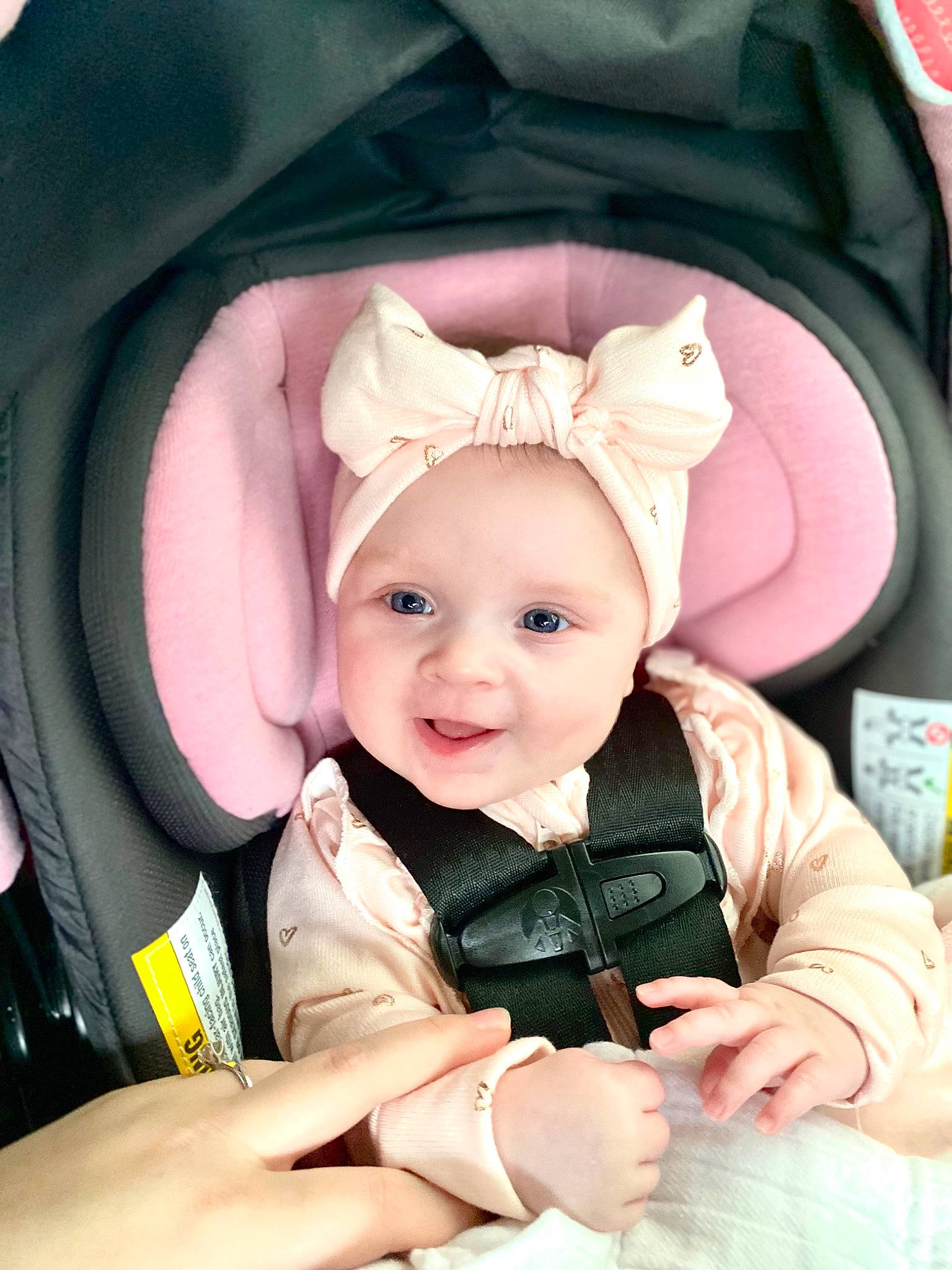 Elliana joined the competition — help win amazing prizes! baby, baby_carriage, baby_in_car_seat, baby_safety, baby_toddler_clothing, cheek, child, comfort, finger, happy, head, person, photograph, pink, product, skin, sleeve, smile, textile, toddler