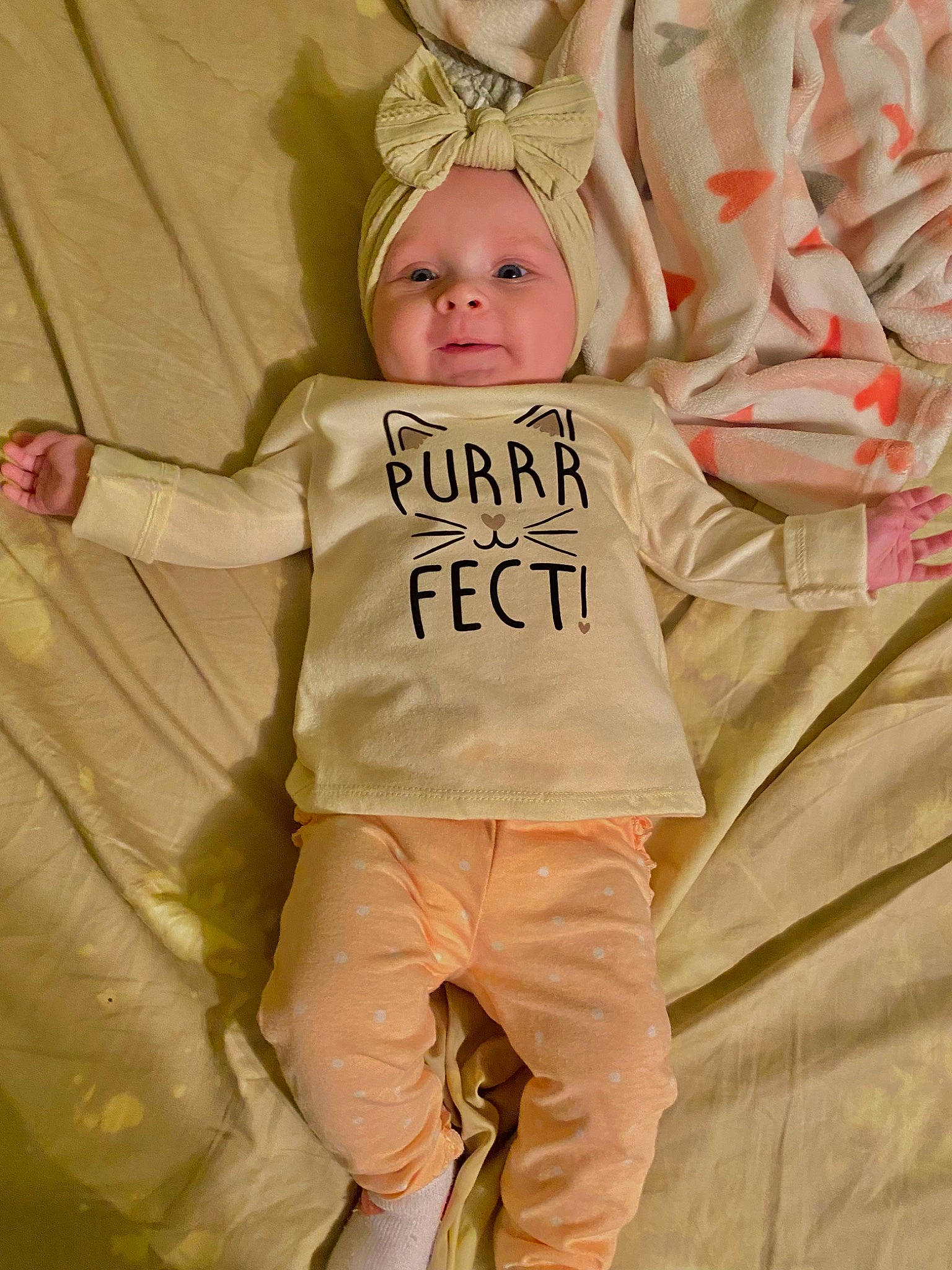 Elliana joined the competition — help win amazing prizes! baby, baby_products, baby_toddler_clothing, child, comfort, event, fun, fur, gesture, happy, headpiece, headwear, linens, peach, person, pink, sitting, sleeve, smile, t_shirt