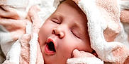 Ivy joined the competition — help win amazing prizes! baby, sleeping, yawning, blanket, soft, fluffy, close_up, face, peaceful, infant, cute, skin, wrapped, cozy, child, newborn, resting, pink, white, portrait