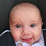 baby, infant, face, smile, eyes, car_seat, clothing, white_shirt, black_strap, cute, child, young, portrait, close_up, happy, skin, head, button, seatbelt, babywearing