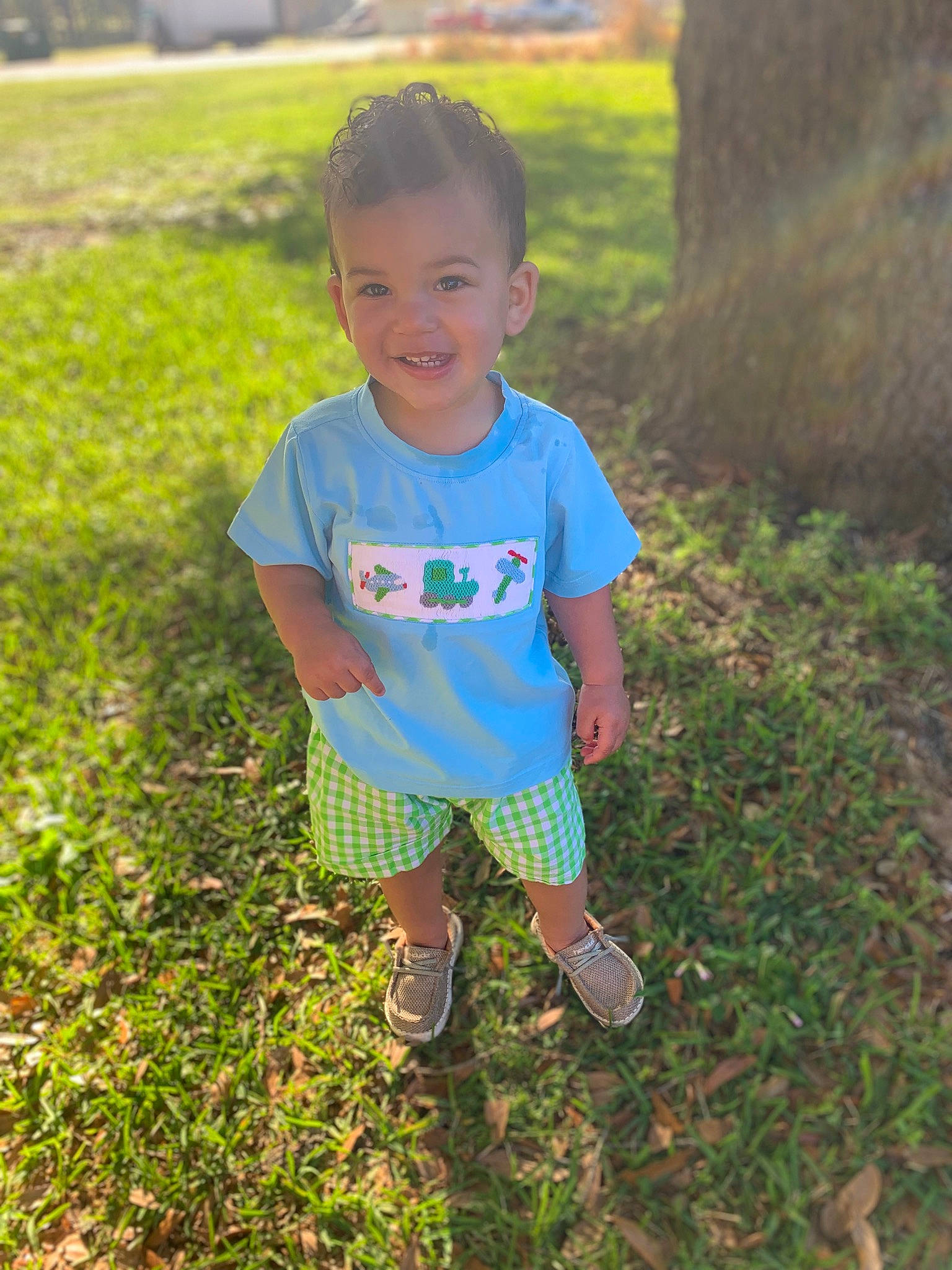 Korbyn joined the competition — help win amazing prizes! baby_toddler_clothing, face, grass, grass_family, grassland, groundcover, hair, happy, head, joy, landscape, lawn, people_in_nature, person, plant, shorts, sleeve, smile, soil, summer