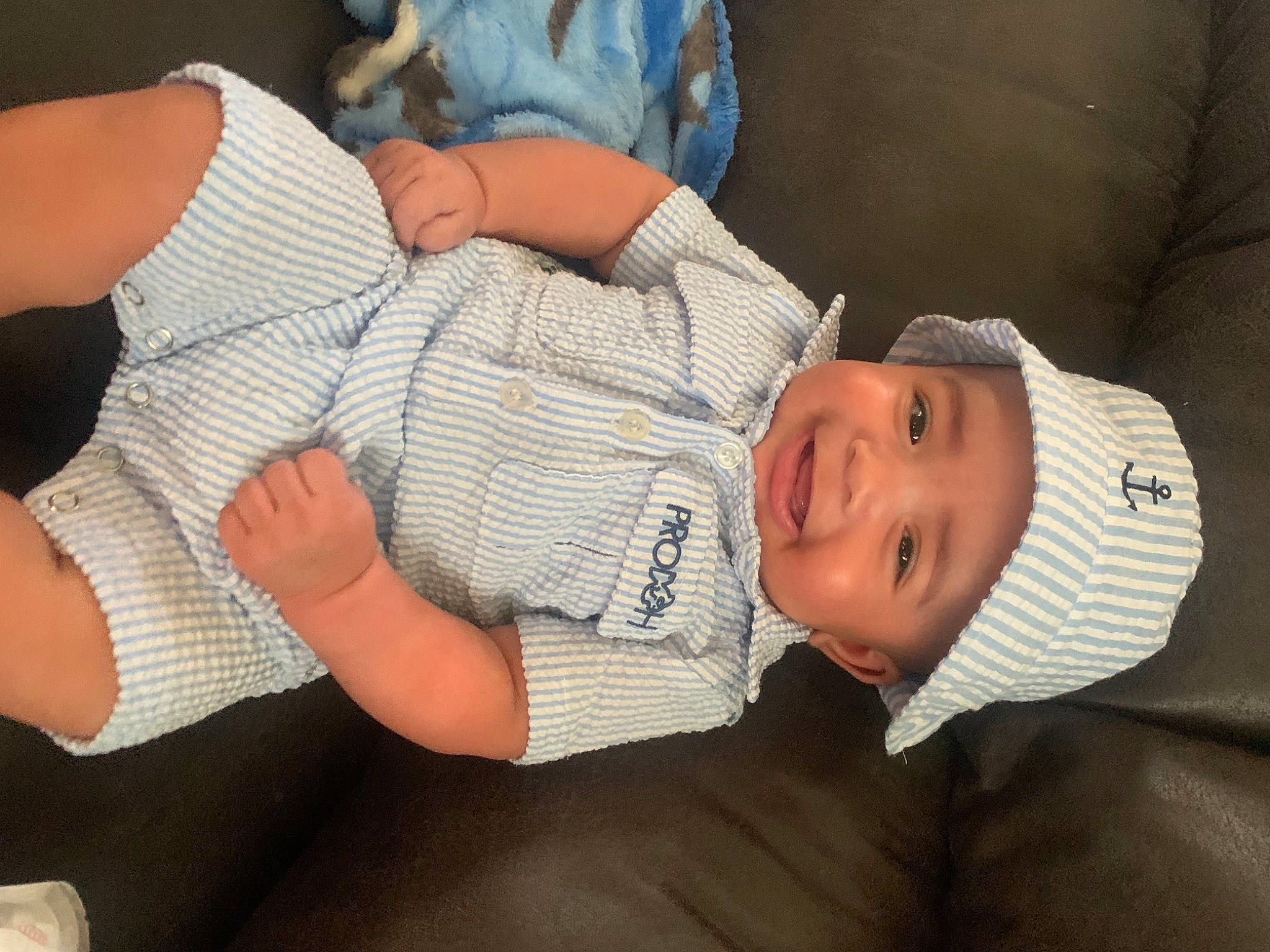 Khyzen is registered to the contest to win money with this photo: arm, baby, baby_toddler_clothing, child, clothing, comfort, elbow, eye, gesture, hat, headwear, human_body, joint, joy, knee, mouth, person, skin, sleeve, smile