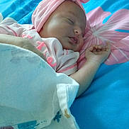Kinsley joined the competition — help win amazing prizes! baby, sleeping, blanket, bed, headband, pink, blue, floral, infant, cute, peaceful, resting, child, soft, cozy, portrait, indoors, clothing, hand, face