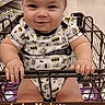 baby, child, infant, smiling, portrait, grocery_store, shopping_cart, superhero_clothing, batman, store_aisle, indoors, retail, sitting, hands, bare_legs, cart, shelves, shopping, happy, photograph