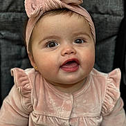 Antonia joined the competition — help win amazing prizes! baby, infant, child, pink_headband, bow, pink_clothing, portrait, face, eyes, smile, cute, cozy, soft_texture, indoors, seated, closeup, adorable, young_child, expression, headwear