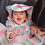 baby, child, smiling, hat, colorful_clothing, blanket, indoor, happy, person, face, infant, seated, fabric, playful, car_seat, tissue, pink, white, cute, joyful