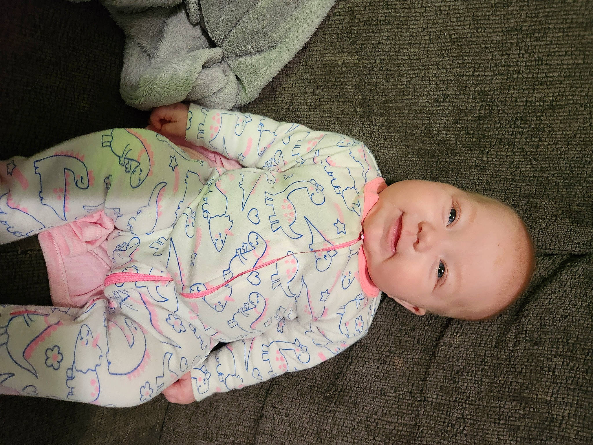 Skylar is registered to the contest to win money with this photo: arm, baby, baby_products, baby_toddler_clothing, cheek, child, comfort, elbow, facial_expression, finger, hand, hat, human_body, human_leg, linens, nose, pattern, person, skin, sleeve