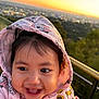 Dalilah Castillo is registered to the contest to win money with this photo: baby, child, hoodie, pink_clothing, smiling, happy, face, portrait, sunset, outdoor, cityscape, blurred_background, minnie_mouse, cute, young_child, nature, railing, person, warm_light, daylight