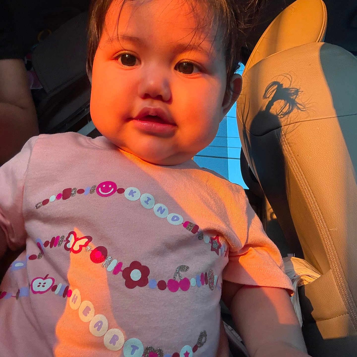 Dalilah Castillo is registered to the contest to win money with this photo: baby, car_interior, casual_clothing, child, closeup, curly_hair, cute, expression, face, indoors, person, pink_shirt, portrait, seat, seatbelt, sunlight, toddler, warm_light, window, young_child