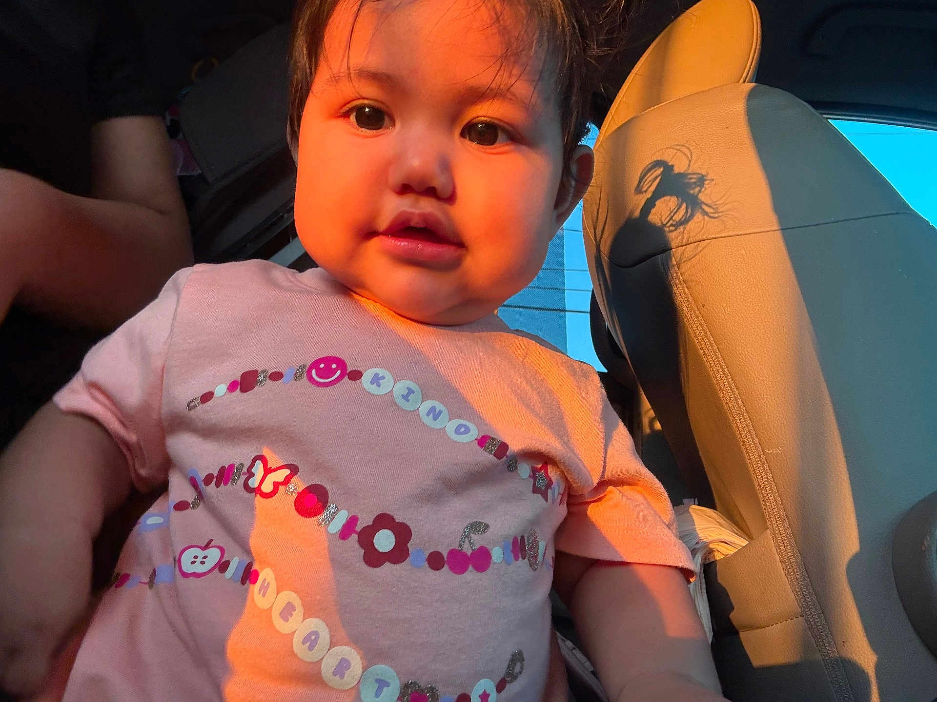 Dalilah Castillo is registered to the contest to win money with this photo: toddler, child, face, pink_shirt, car_interior, sunlight, warm_light, curly_hair, cute, portrait, baby, seat, seatbelt, window, expression, person, indoors, casual_clothing, closeup, young_child