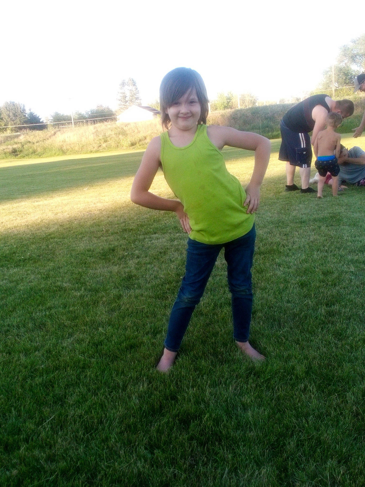 Abigail is registered to the contest to win money with this photo: barefoot, fun, gesture, grass, grassland, happy, joy, landscape, leisure, meadow, pasture, people_in_nature, person, plant, play, prairie, recreation, shorts, sky, smile