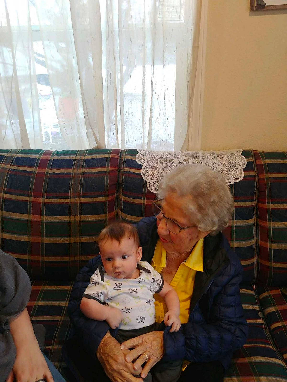 Gage joined the competition — help win amazing prizes! baby, chair, child, comfort, couch, curtain, event, fun, holiday, human, lap, living_room, pattern, person, plaid, room, sitting, tartan, toddler, window