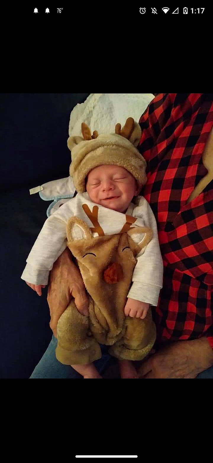 Kohen is registered to the contest to win money with this photo: baby, baby_toddler_clothing, cheek, child, comfort, fur, gesture, happy, hat, headwear, pattern, person, plaid, sleeve, smile, tartan, thumb, toddler