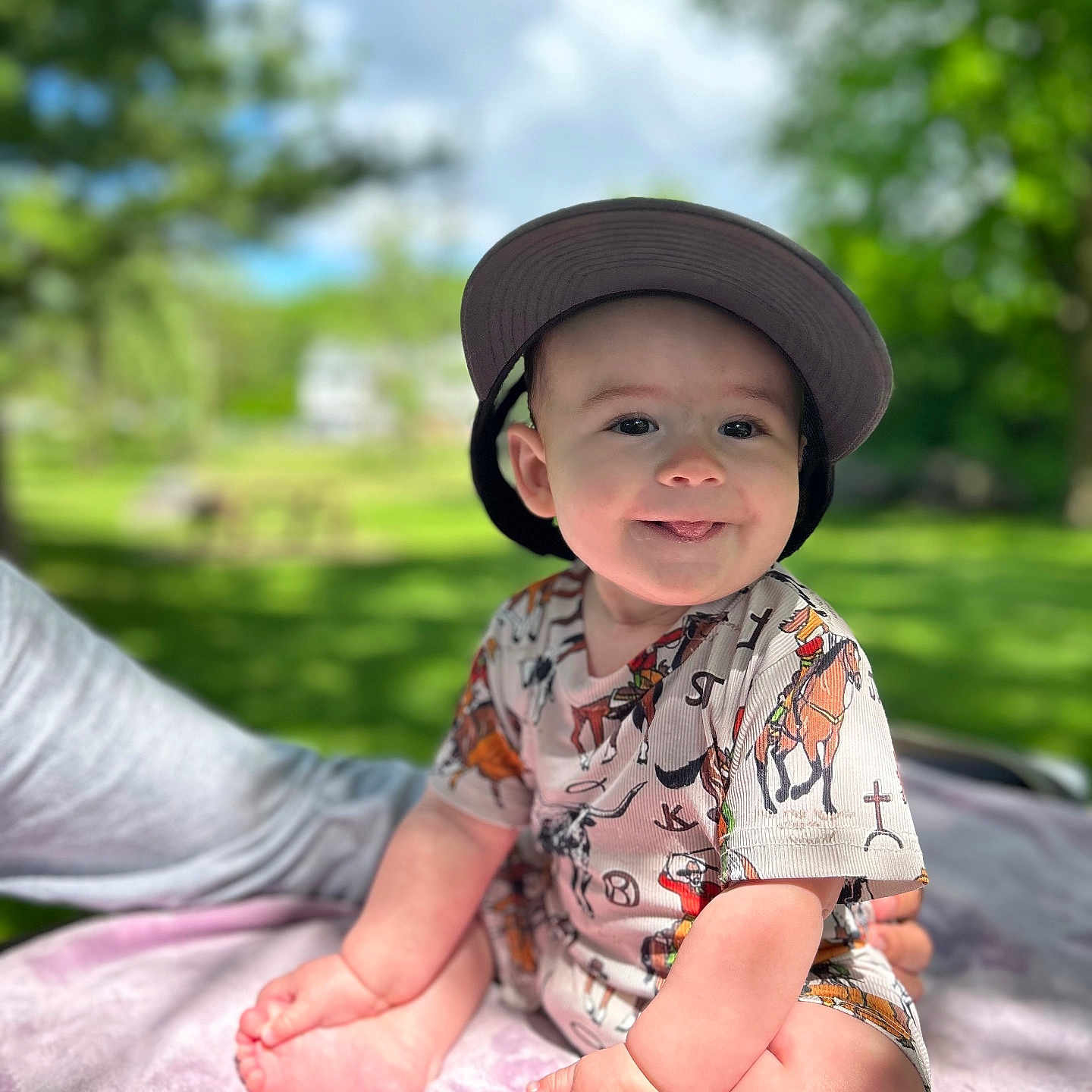 Matt joined the competition — help win amazing prizes! baby, baseballcap, cap, clothing, dress, face, grass, happy, hat, head, nature, outdoors, park, person, photography, plant, portrait, sitting, smile, t_shirt