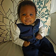 Amari is registered to the contest to win money with this photo: baby, child, clothing, couch, cute, fabric, face, feet, hands, home, indoors, infant, pattern, person, pillow, portrait, seated, shirt, smile, suit