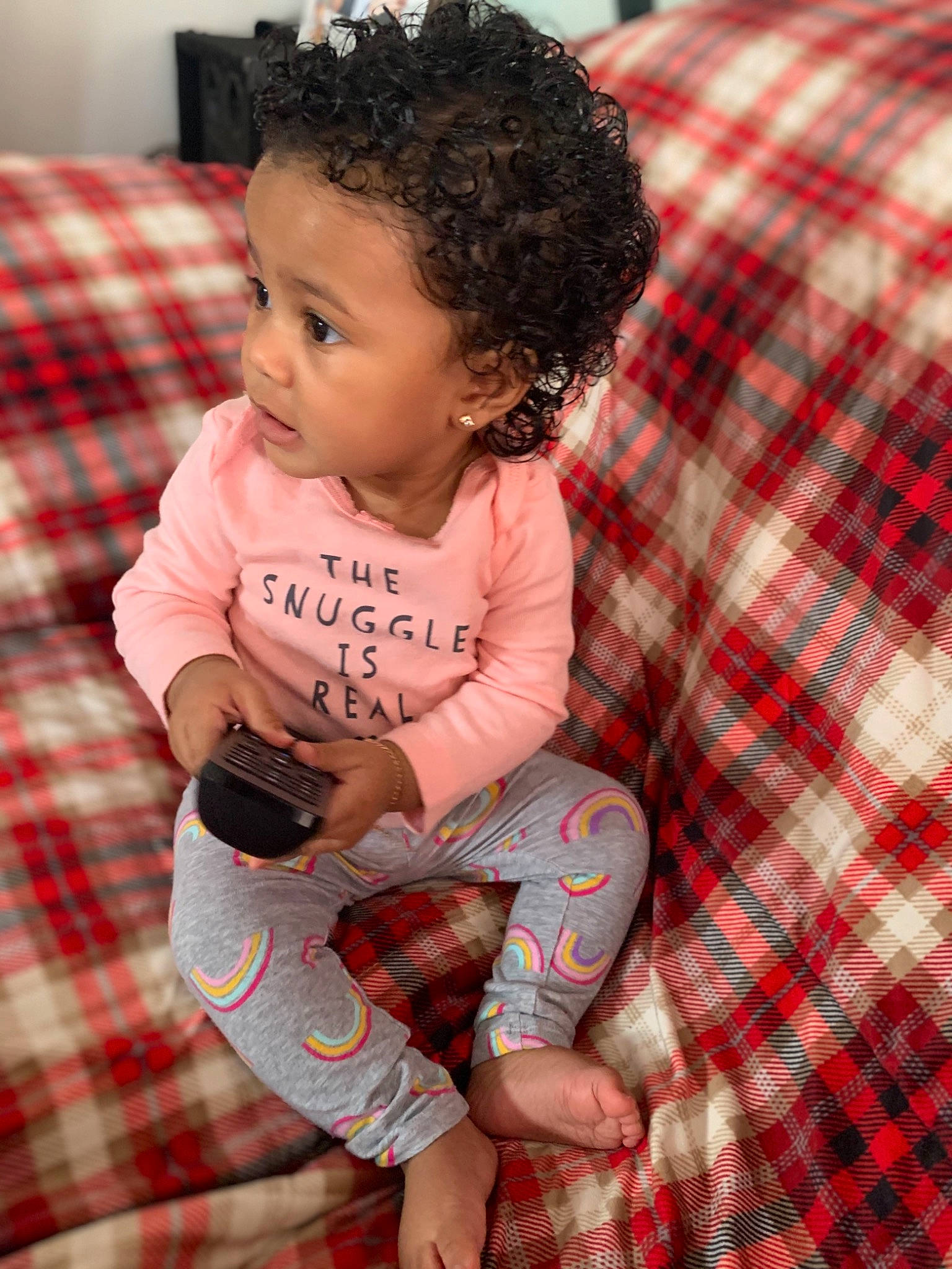 Riley is registered to the contest to win money with this photo: baby, child, design, pajamas, pattern, person, plaid, sitting, smile, tartan, textile, toddler