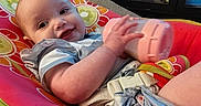Emma joined the competition — help win amazing prizes! baby, bottle, cabinet, carpet, casual, child, clothing, cushion, door, drool, face, furniture, hand, happy, indoor, infant, person, room, seat, smile