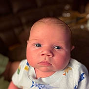 Wyatt is registered to the contest to win money with this photo: baby, child, infant, face, blue_eyes, chubby_cheeks, onesie, clothing, indoor, portrait, person, cute, young, skin, head, expression, human, baby_girl, baby_boy, newborn