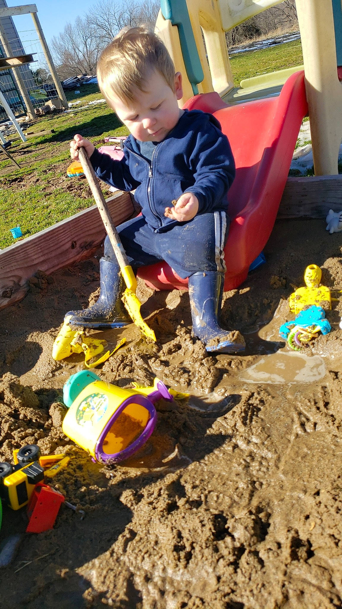 Paxton is registered to the contest to win money with this photo: child, city, fun, garden_tool, gardening, grass, green, outdoor_play_equipment, people_in_nature, person, plant, play, playground, recreation, sand, shovel, soil, t_shirt, toddler, tool