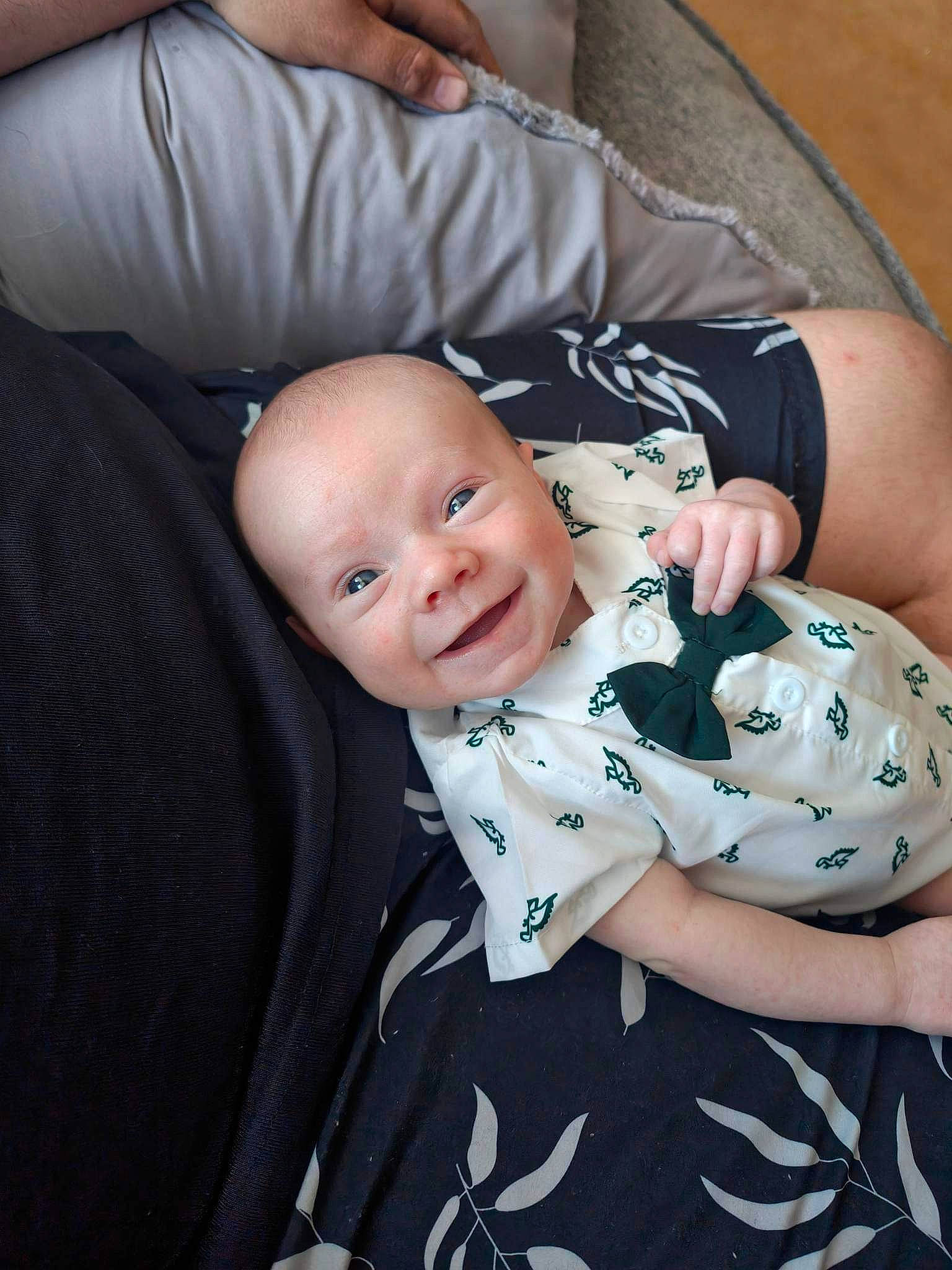 George is registered to the contest to win money with this photo: baby, baby_products, baby_toddler_clothing, cheek, child, comfort, elbow, flash_photography, formal_wear, fun, grass, happy, joy, pattern, person, portrait_photography, sitting, sleeve, smile, t_shirt