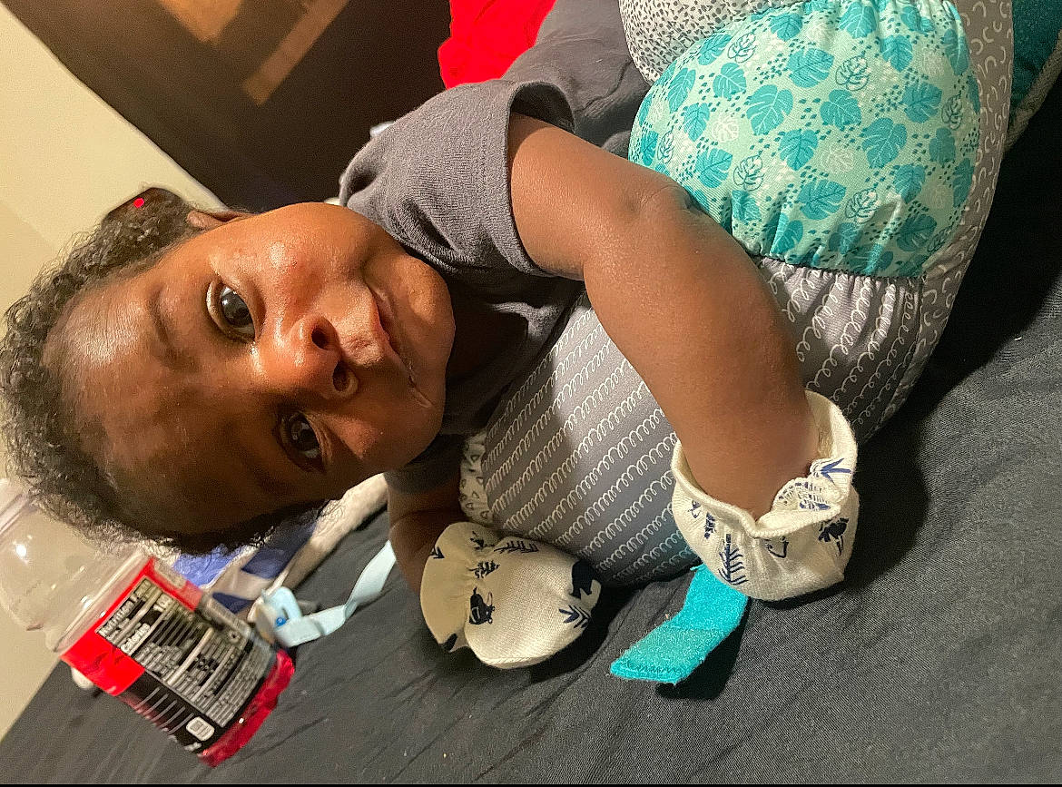 Jrue is registered to the contest to win money with this photo: audio_equipment, child, cool, elbow, eyelash, eyewear, fashion_accessory, flooring, fun, happy, human_leg, nail, pattern, person, plaid, play, selfie, sitting, thigh, toddler