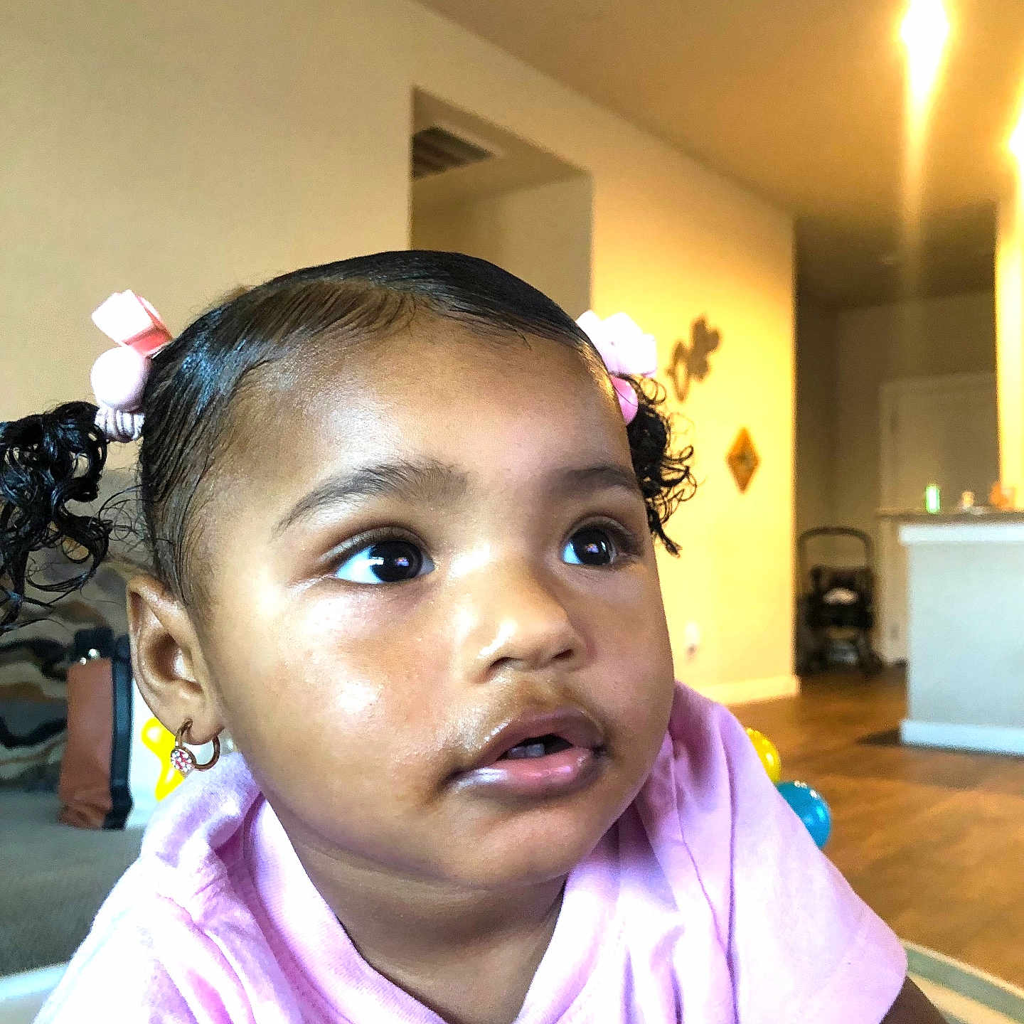 Lilly joined the competition — help win amazing prizes! toddler, child, indoor, face, pigtails, pink_bows, curly_hair, earrings, pink_shirt, living_room, home_interior, furniture, flooring, wall_decor, soft_lighting, expression, person, portrait, young_child, cute