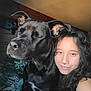 Atlas participe au concours pour gagner de l'argent avec cette photo : person, dog, black_dog, pet, smiling, curly_hair, indoor, bedroom, bedding, zebra_pattern, leaf_pattern, closeup, selfie, septum_piercing, happy, snuggling, natural_light, furniture, companion, animal