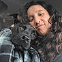 Atlas participe au concours pour gagner de l'argent avec cette photo : person, dog, black_dog, curly_hair, close_up, selfie, plaid_jacket, snuggling, affection, car_interior, nose, brown_eyes, long_hair, face, warmth, companion, animal, pet, cozy, portrait