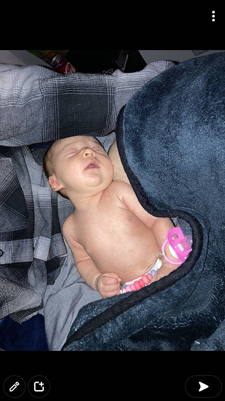 Delilah is registered to the contest to win money with this photo: abdomen, baby, barechested, barefoot, chest, comfort, elbow, eyebrow, gesture, head, human_body, linens, mouth, nail, neck, person, stomach, thigh, thumb, toddler